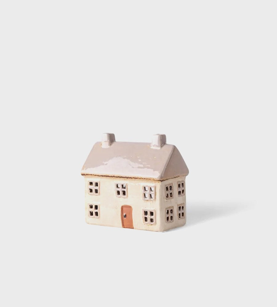 Small ceramic house model on a white background