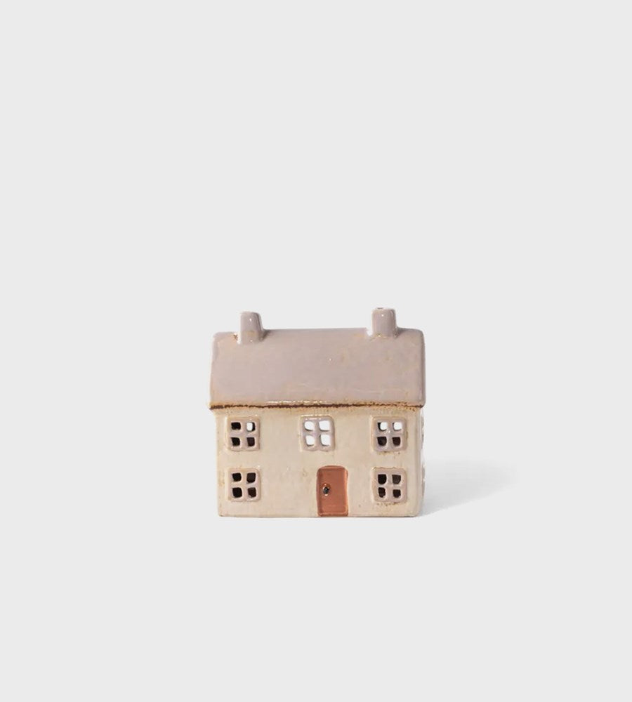 Small ceramic house on a white background