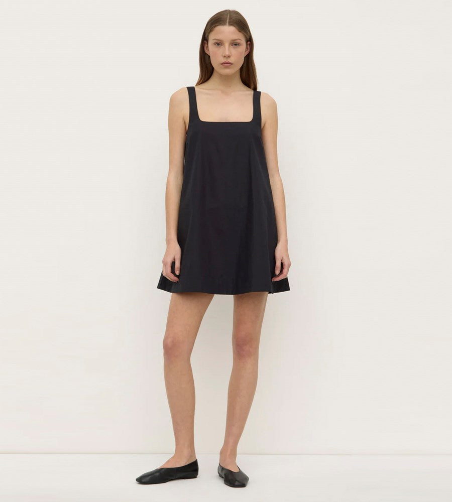 Woman wearing a black sleeveless dress on a white background
