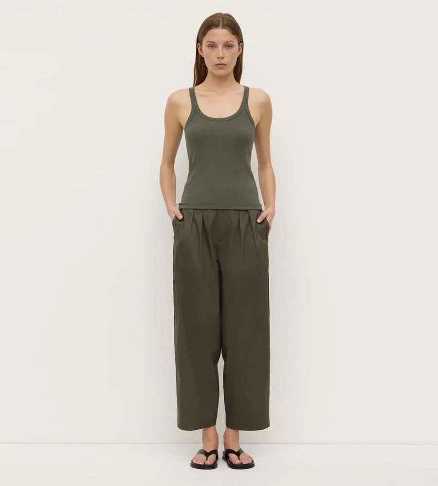 women wearing green assembly label singlet and cotton poplin pants