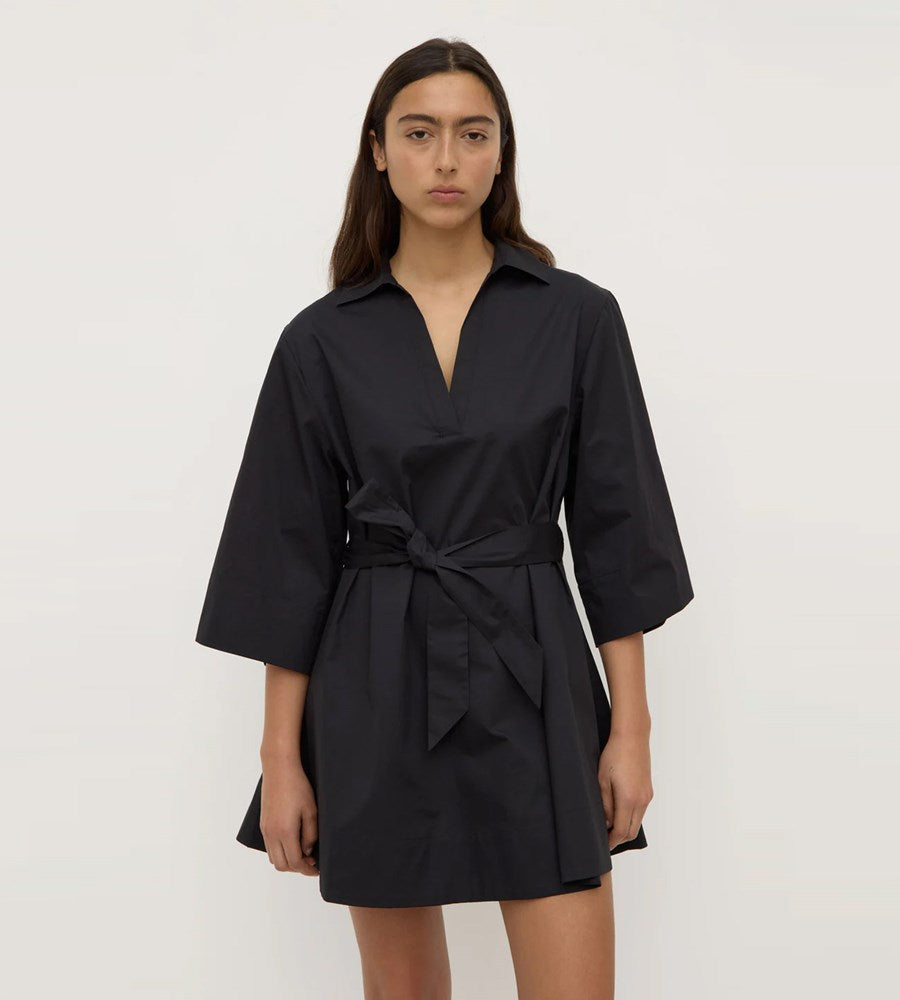 Black dress worn by a model on a white background