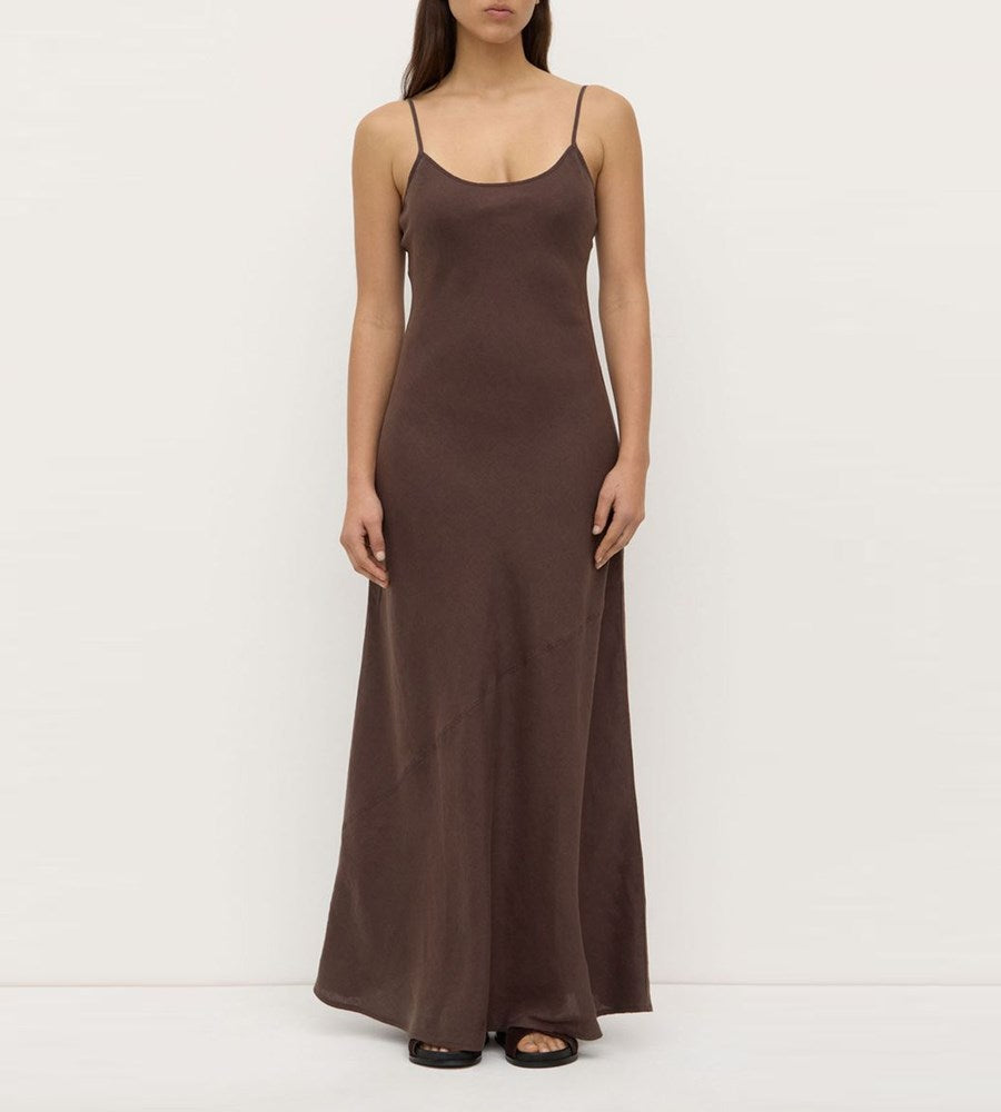 Brown slip dress worn by a model on a white background