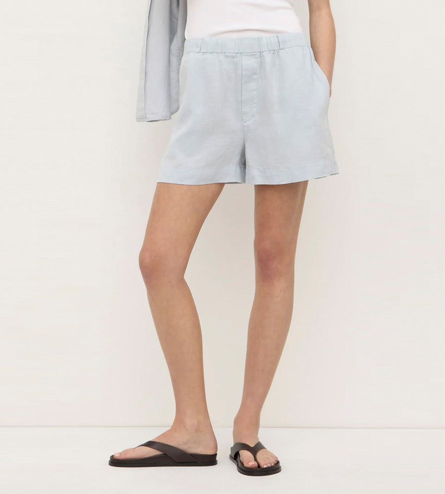 Light blue shorts worn by a person on a plain background