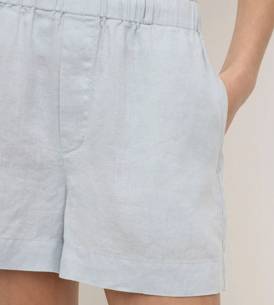 Light blue shorts worn by a person on a neutral background