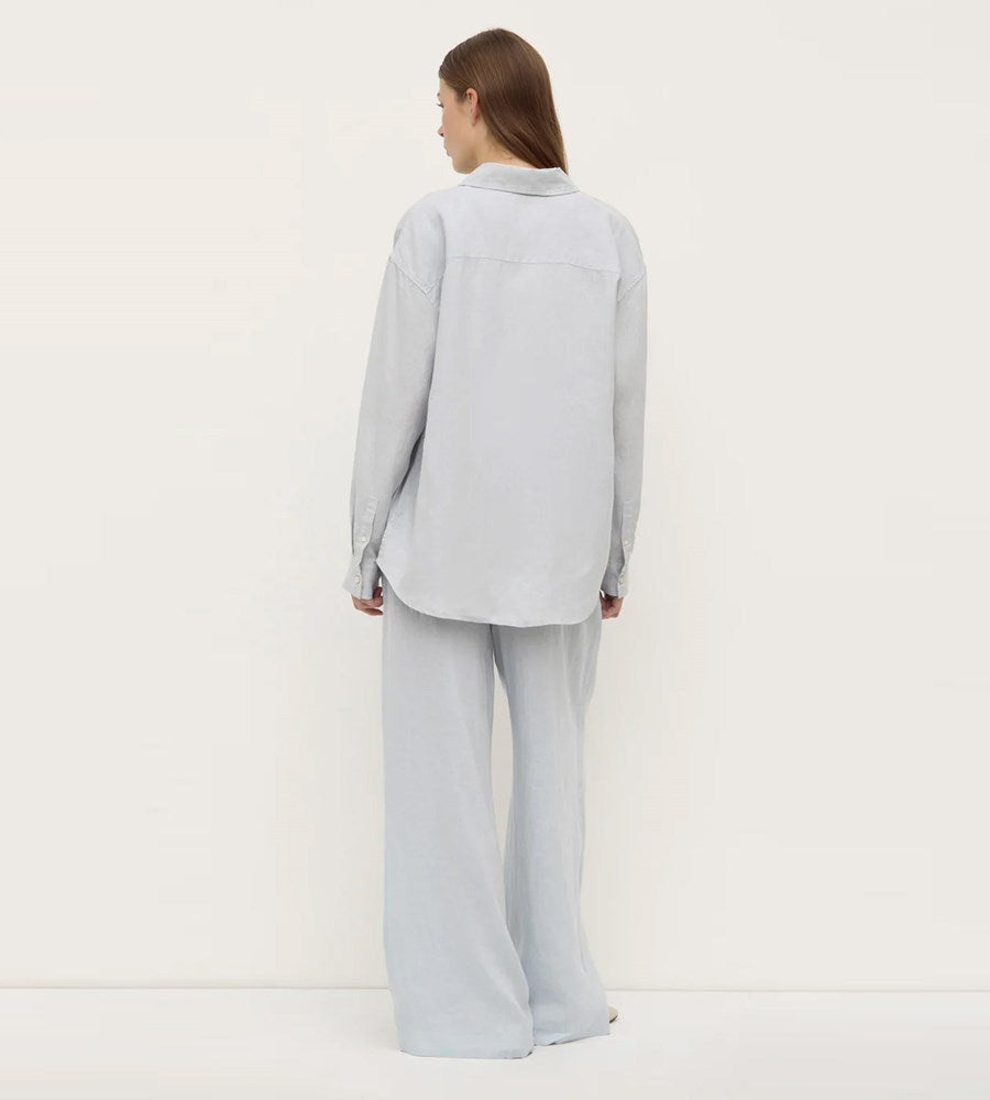 Person wearing a light gray suit on a white background