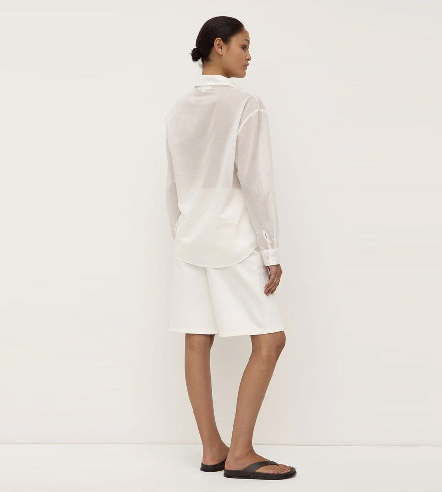 Person wearing a white outfit on a plain background