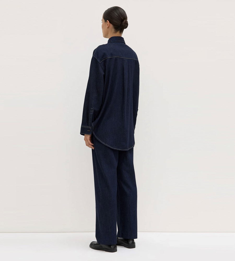Person wearing a navy blue outfit against a white background