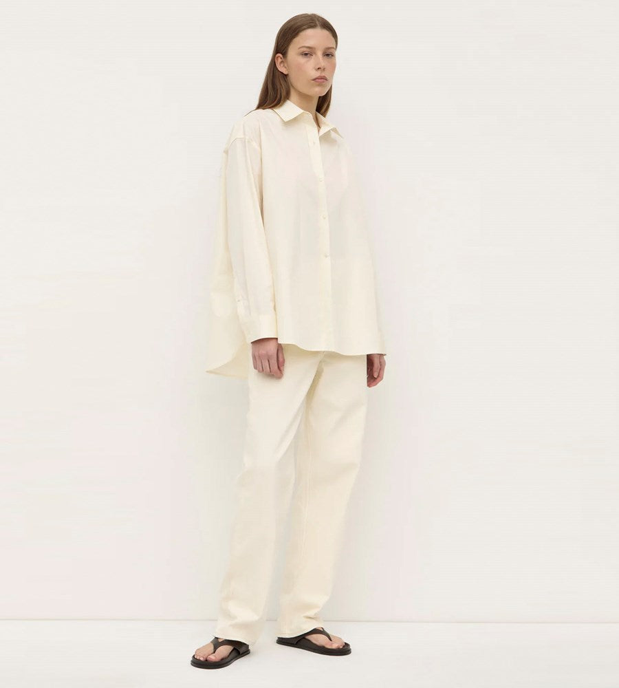 Person wearing a cream-colored outfit on a white background