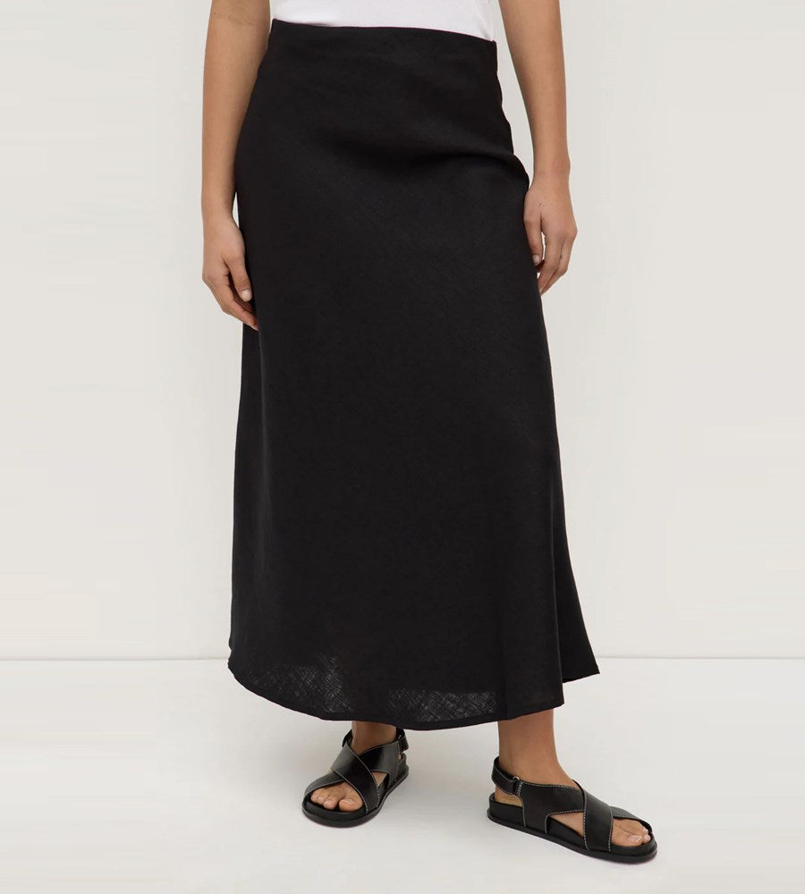 Person wearing a black skirt on a white background