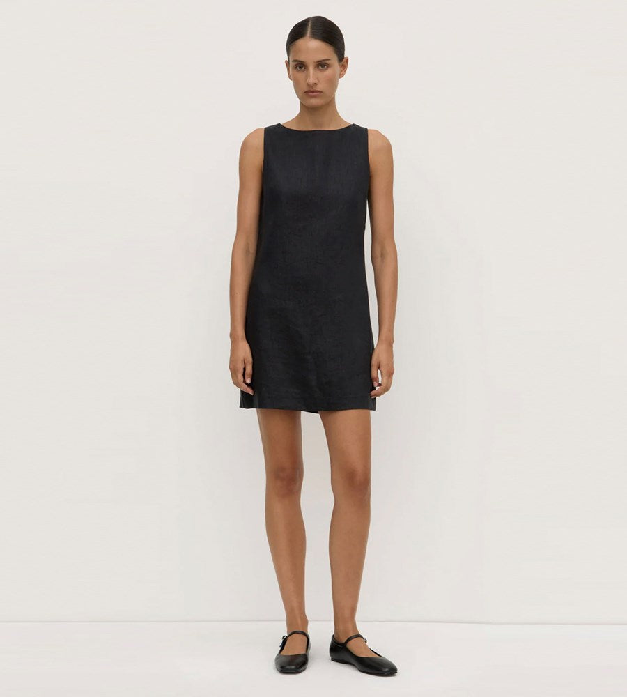 Woman wearing a black sleeveless dress on a white background
