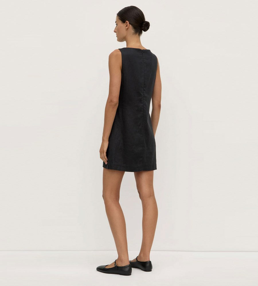 Woman wearing a black sleeveless dress on a white background