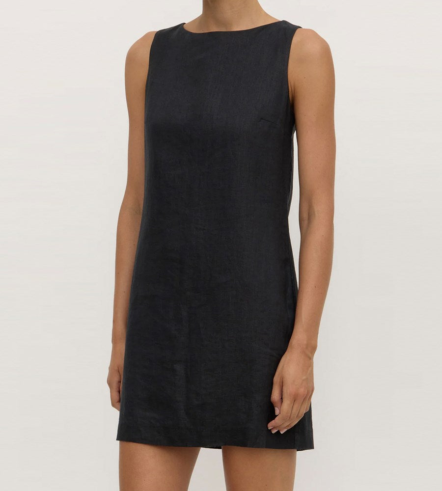 Black sleeveless dress worn by a person on a plain background