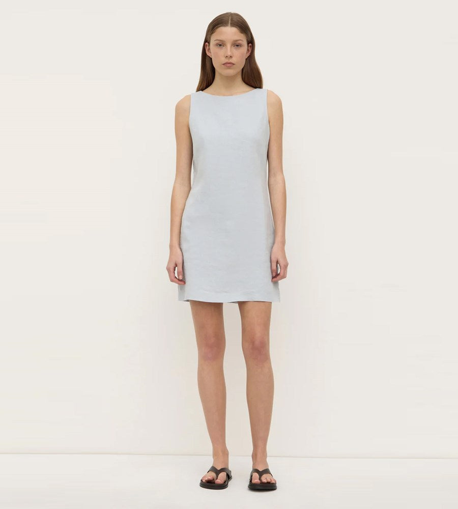 Woman wearing a light blue dress on a white background