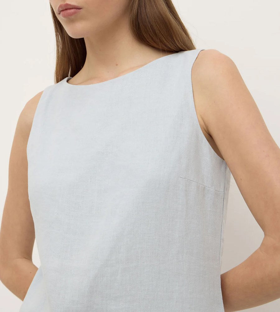 Light blue sleeveless top worn by a person on a plain background