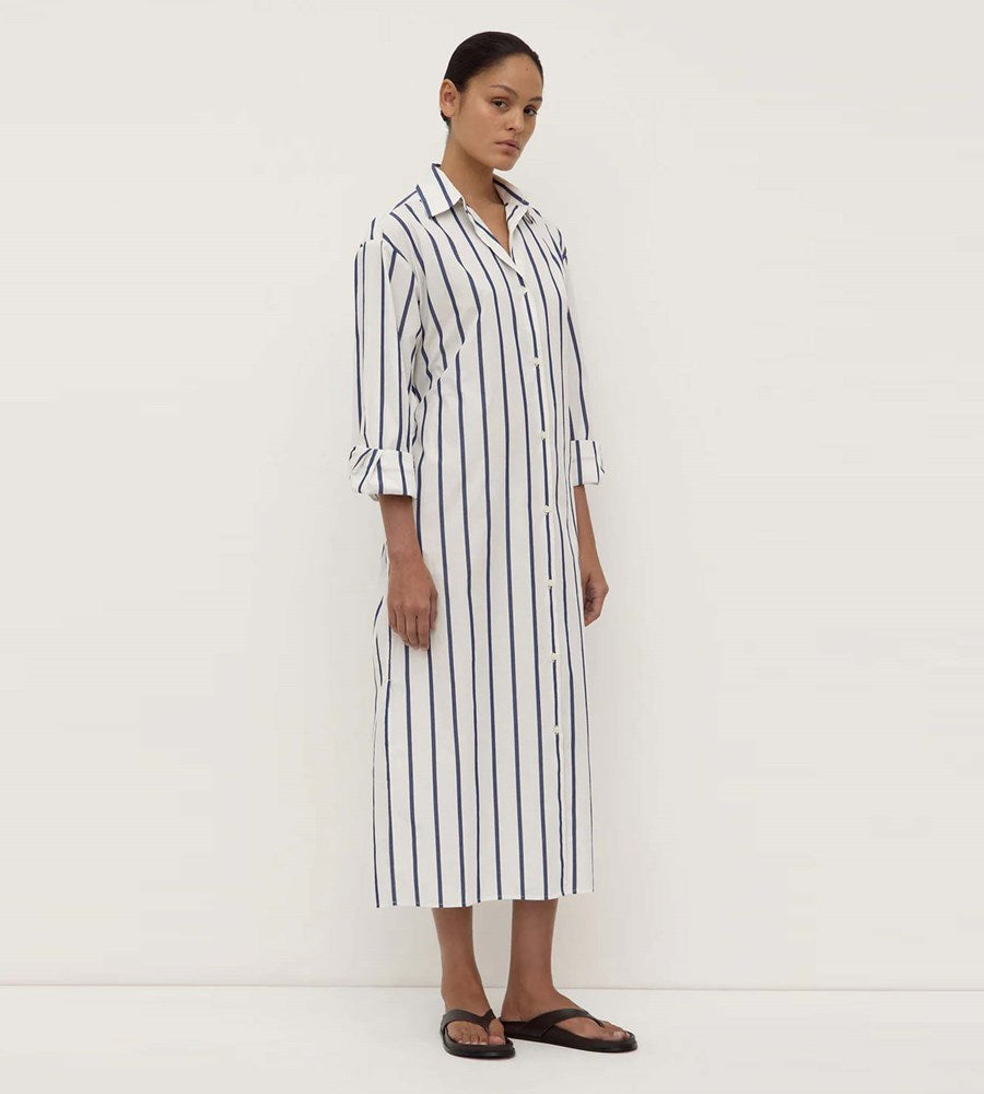 Woman wearing a black and white striped dress on a white background