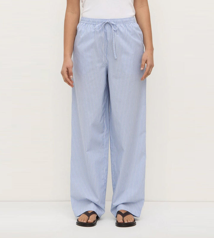 Light blue striped pants worn by a person on a white background