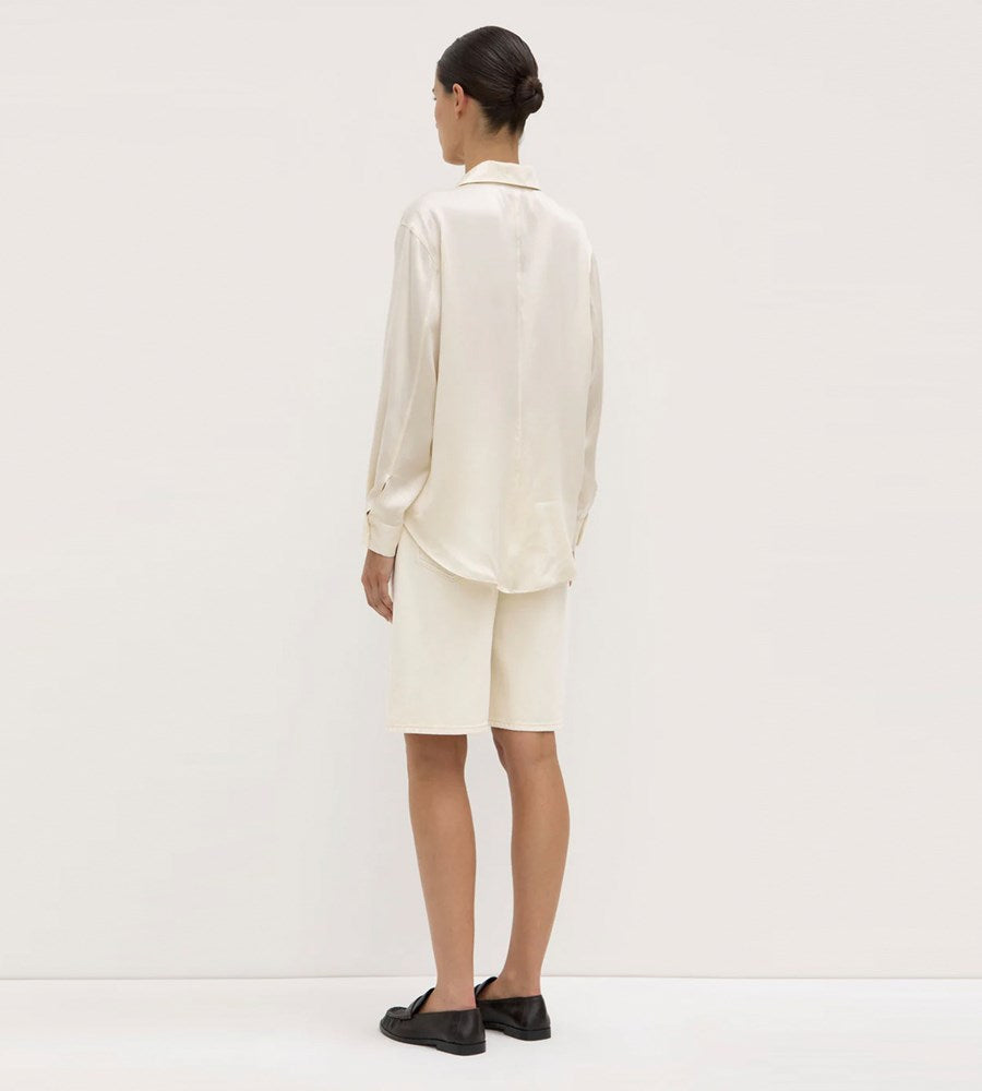 Person wearing a white outfit on a plain background