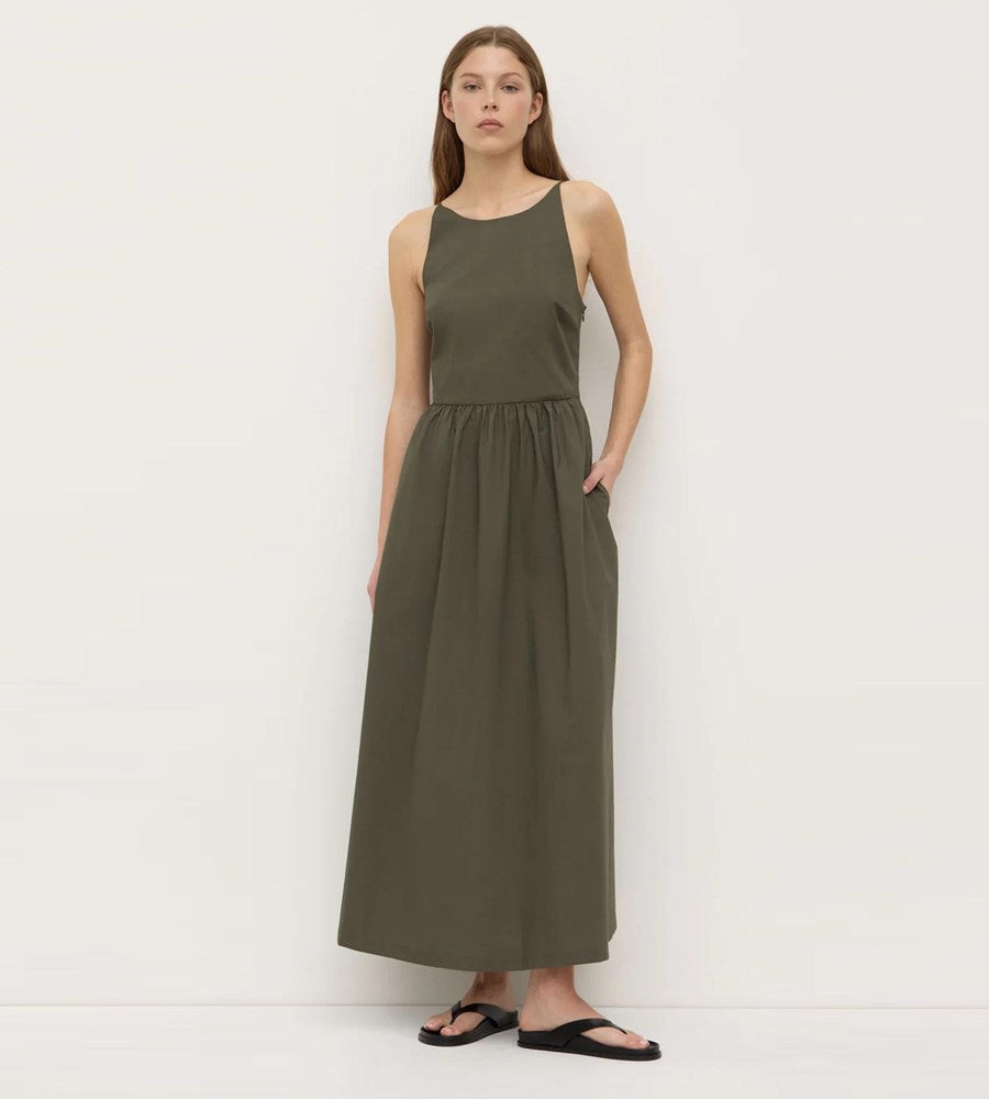 Woman wearing a green dress against a white background