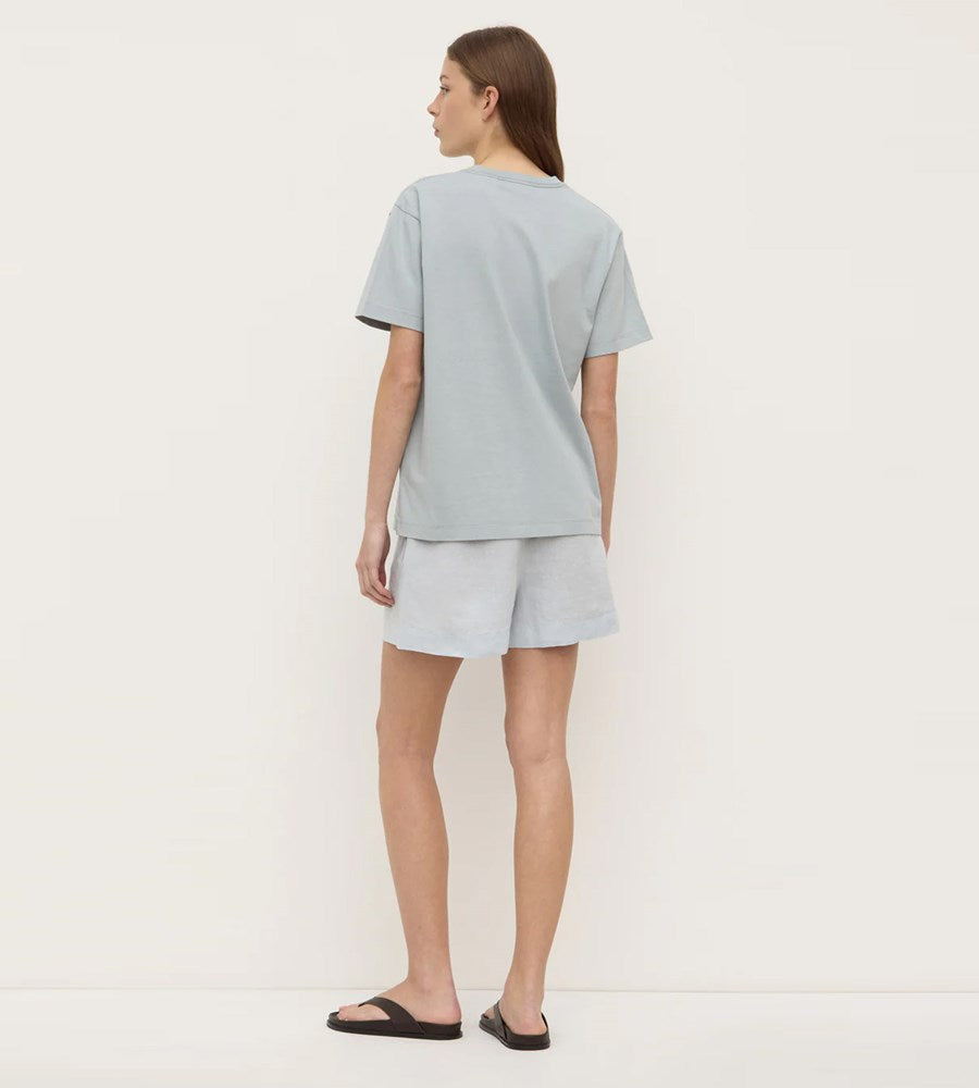 Person wearing a light blue t-shirt and shorts set on a white background