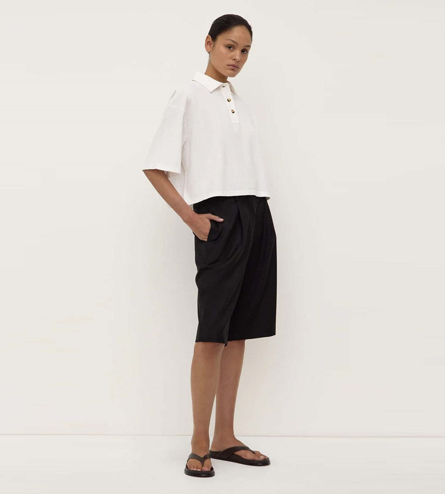 Person wearing a white shirt and black skirt on a white background