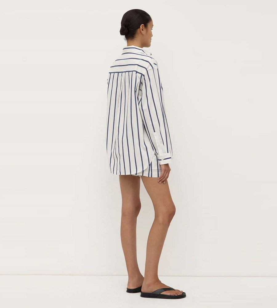 Person wearing a striped shirt against a white background