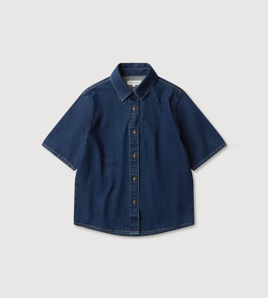 Blue short-sleeve shirt on a light gray background