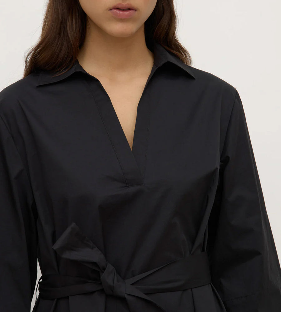 Black shirt worn by a person on a white background