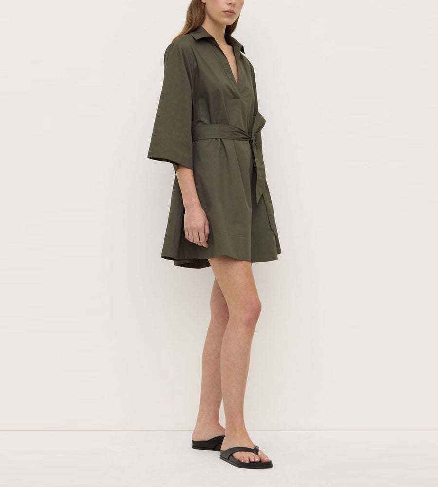 Woman wearing a green dress against a white background