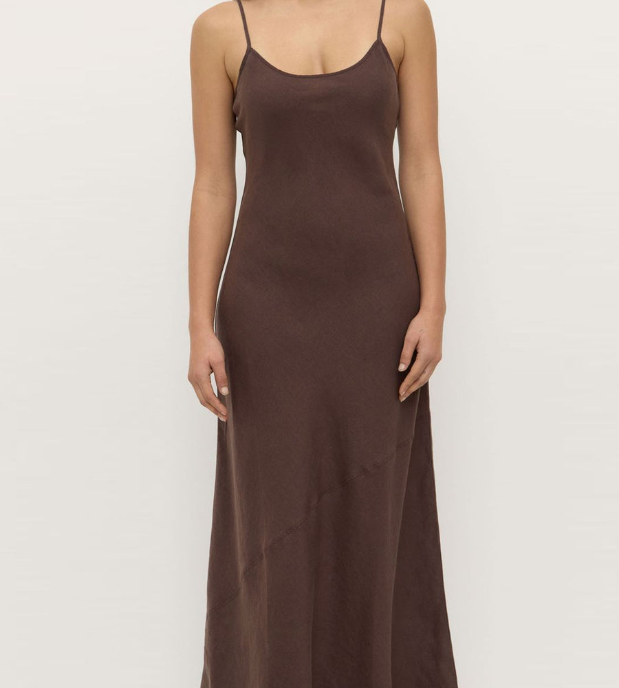 Brown slip dress worn by a model on a light gray background