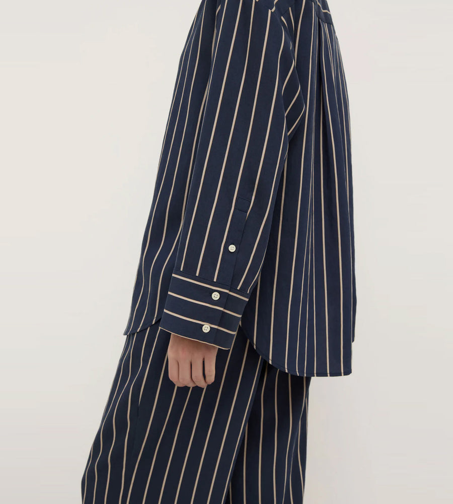Navy pinstripe suit jacket and pants on a white background