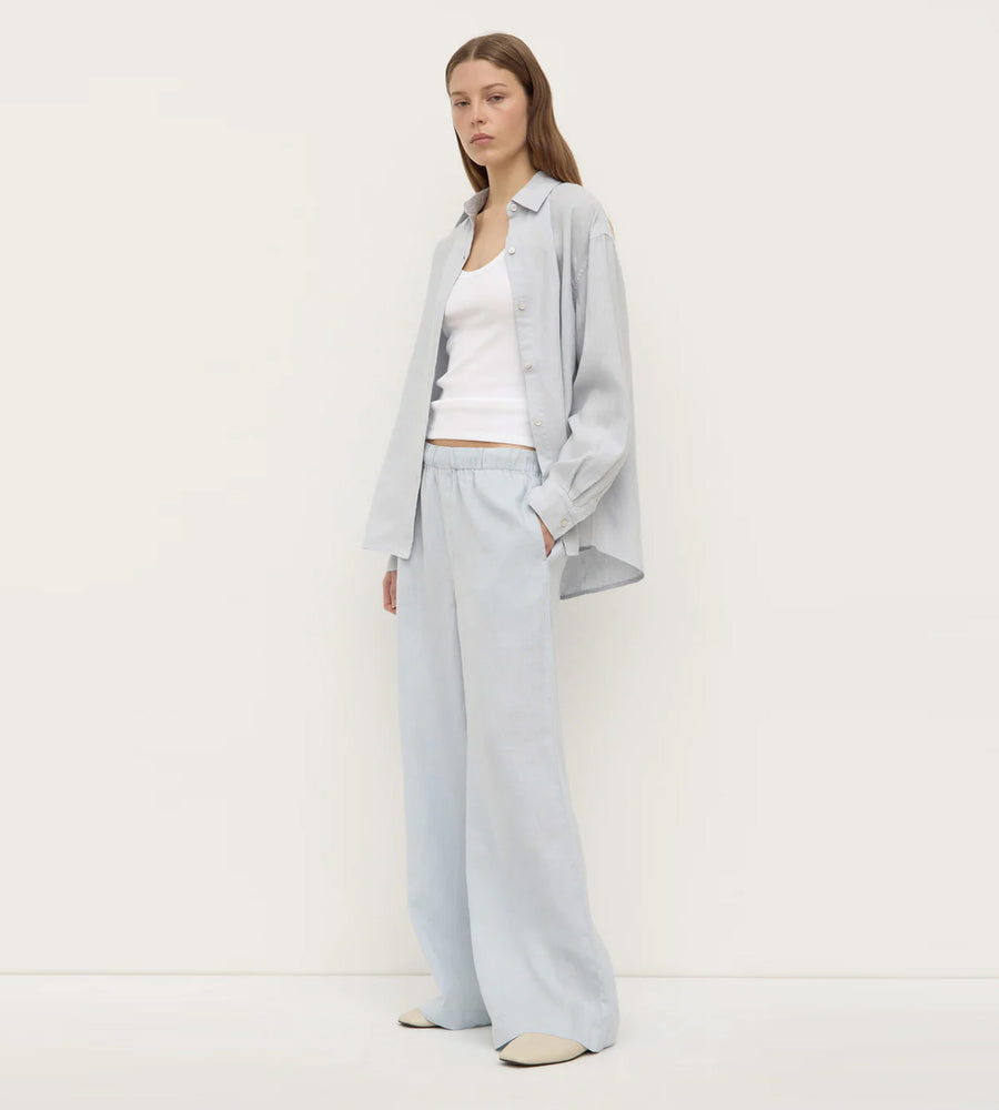 Woman wearing a light gray outfit with a white background