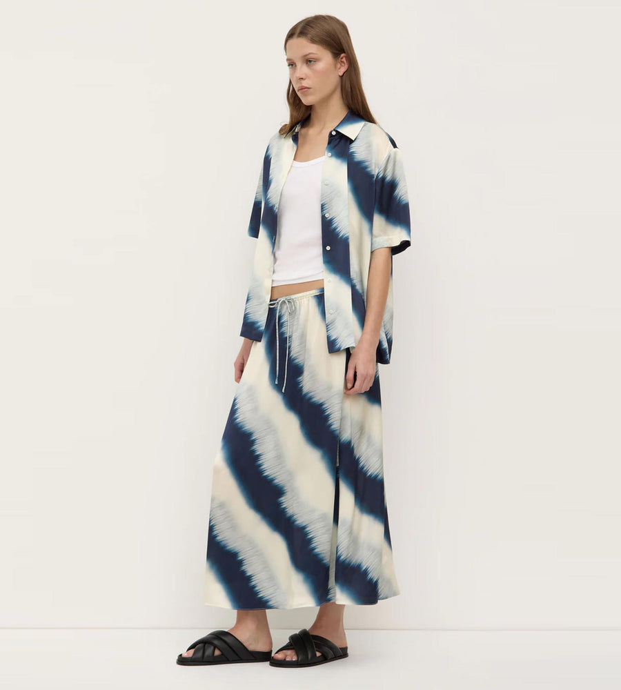 Woman wearing a tie-dye outfit with a white background