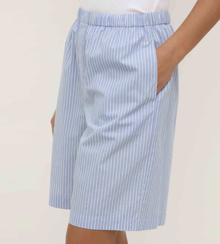 Blue and white striped shorts on a plain background