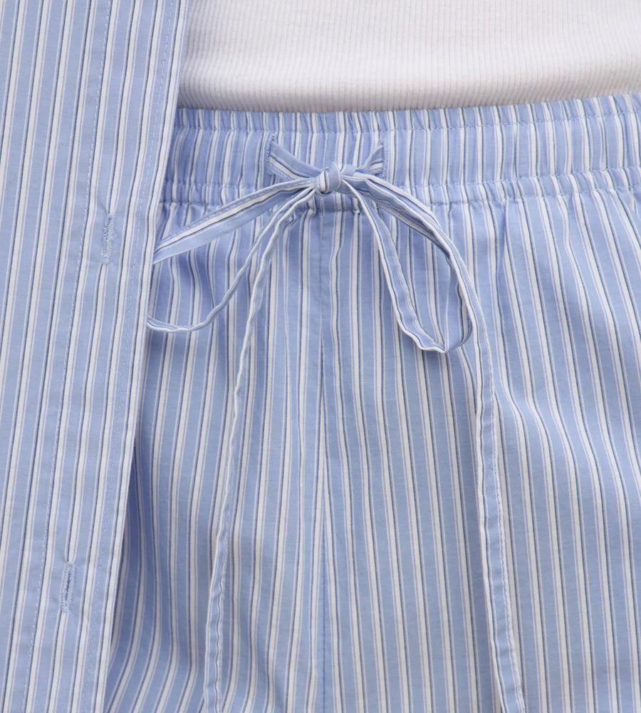 Close-up of blue and white striped pants with a drawstring waistband.
