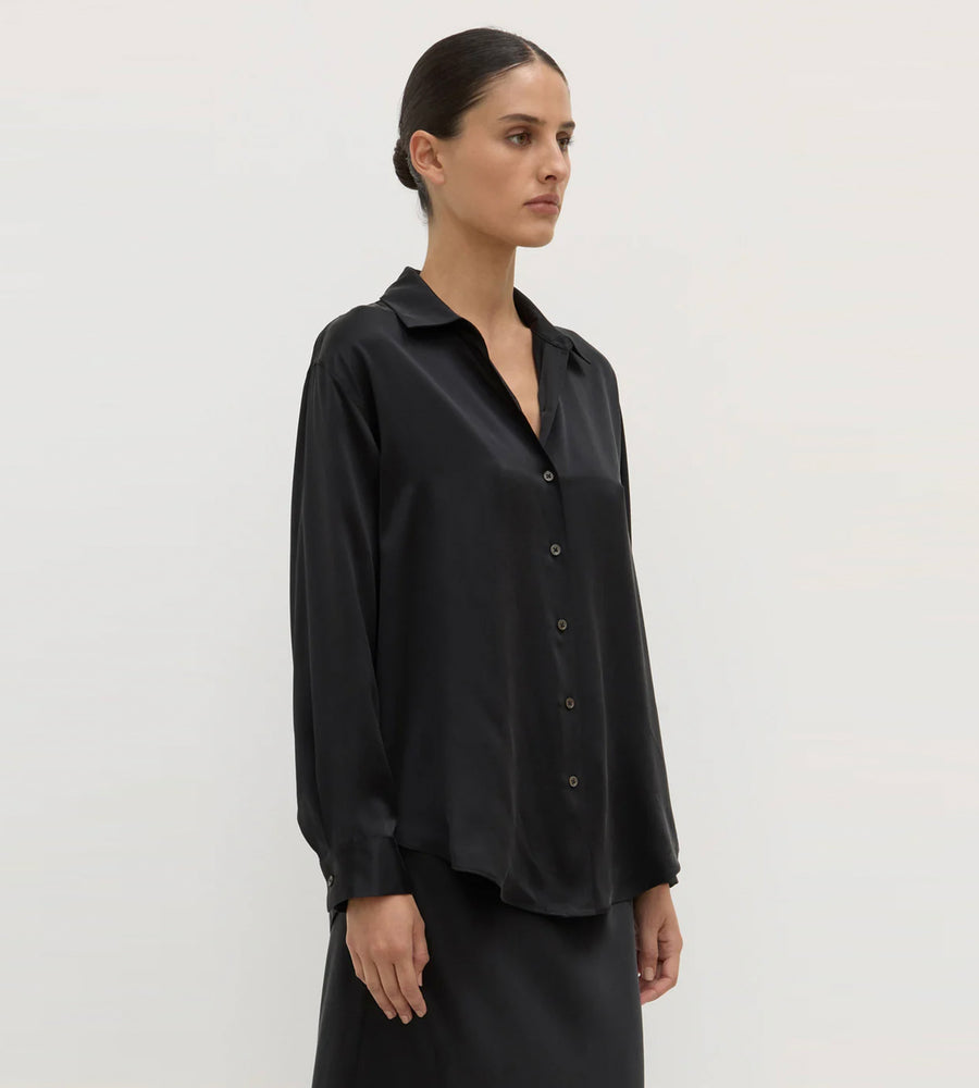 Woman wearing a black shirt against a white background