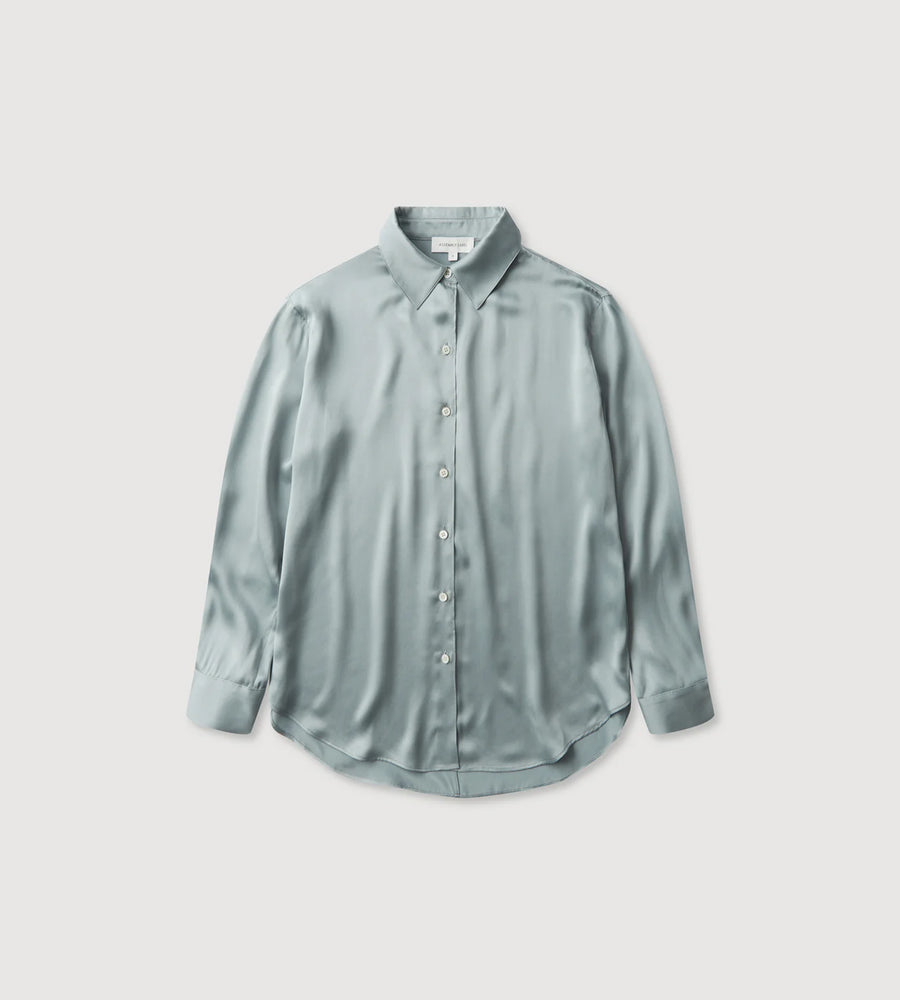 Light blue button-up shirt on a light gray background
