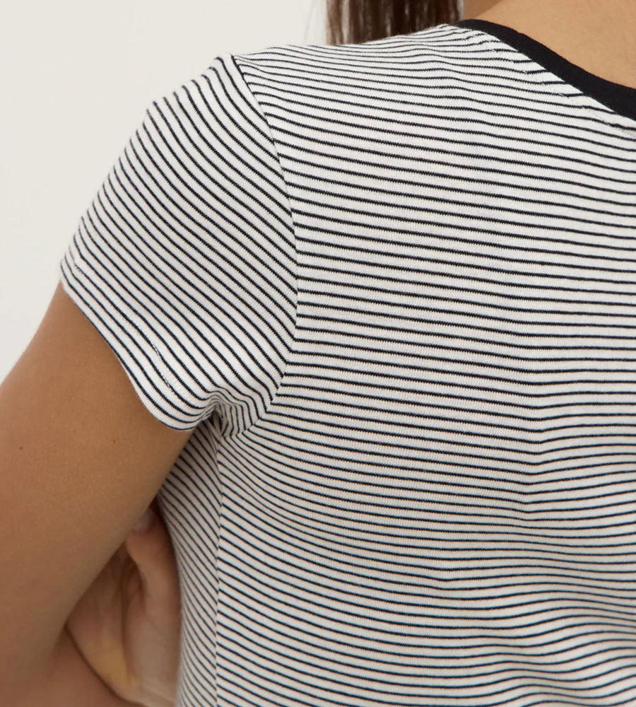 Close-up of a person wearing a black and white striped shirt.