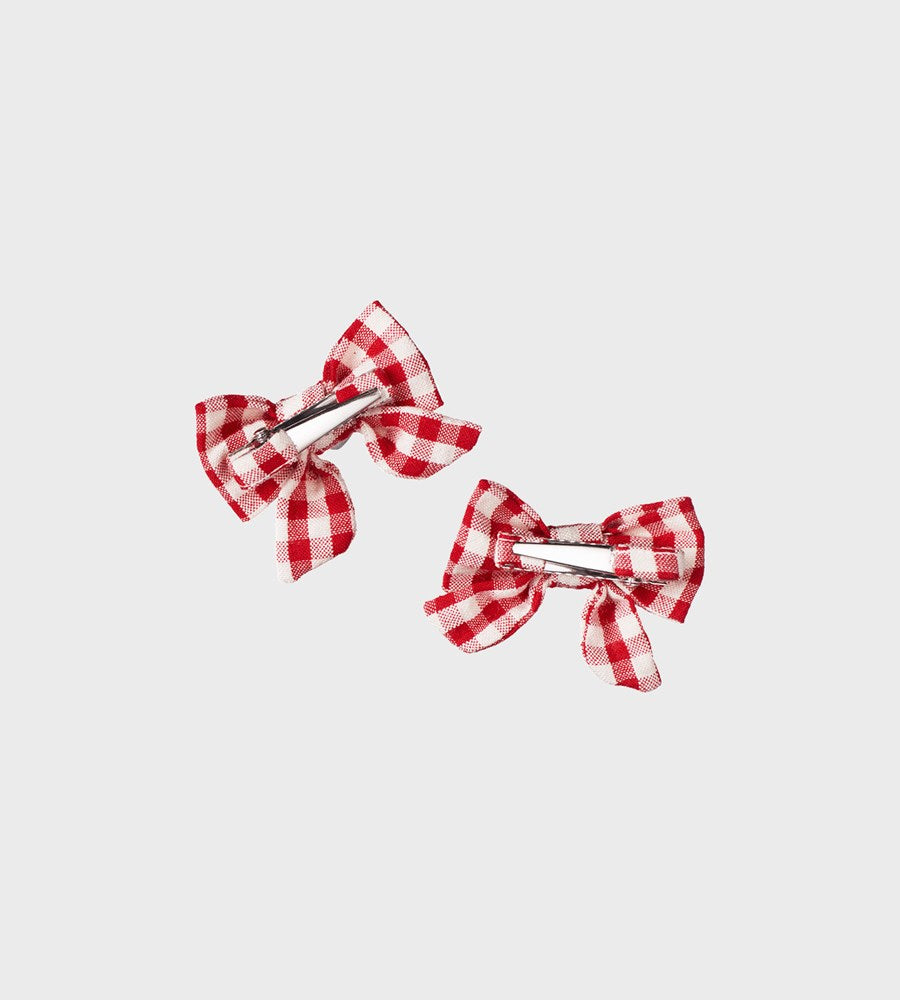 Red and white checkered hair bows on a light gray background