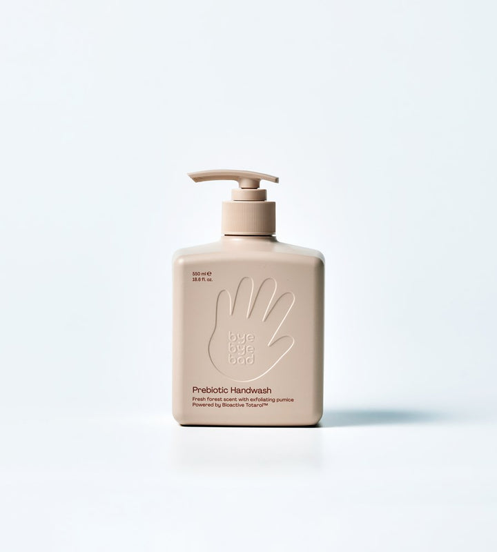 Beige handwash bottle with pump on a light gray background