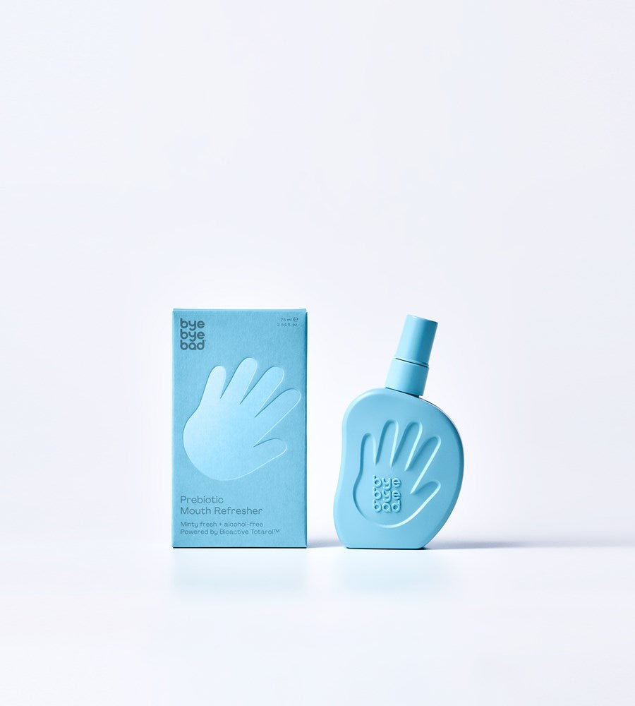 Blue bottle and packaging of a mouth freshener on a light blue background