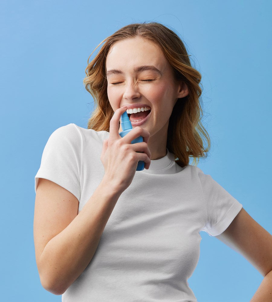 Woman holding a blue object against a light blue background