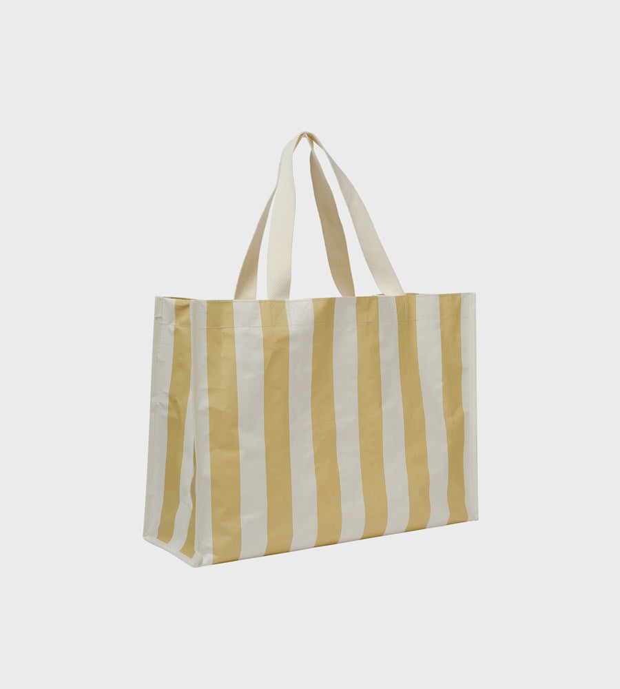 Striped tote bag with yellow and white stripes on a light gray background