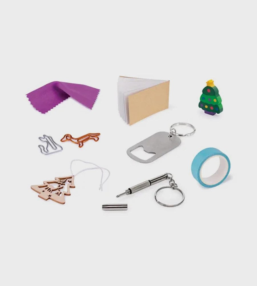 Collection of small items including a purple cloth, bottle opener, keychain, and Christmas tree decorations on a white background.
