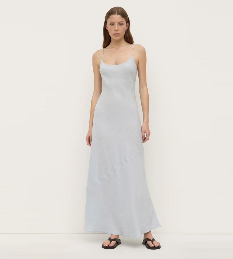 Woman wearing a light blue dress against a white background