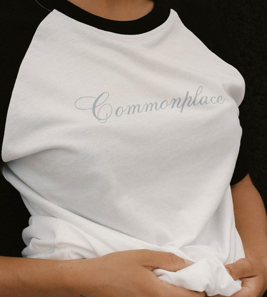 White t-shirt with 'Commonplace' text on a black background