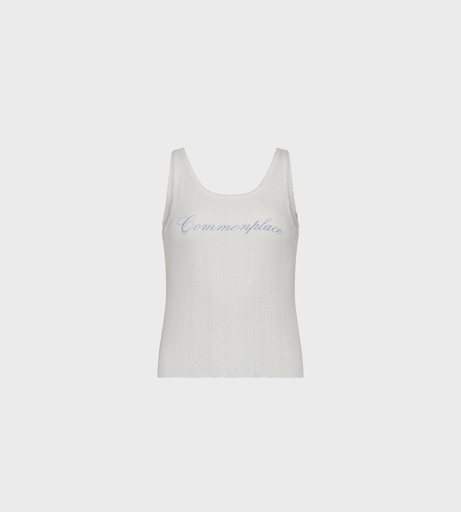 White tank top with 'Commonplace' branding on a light gray background