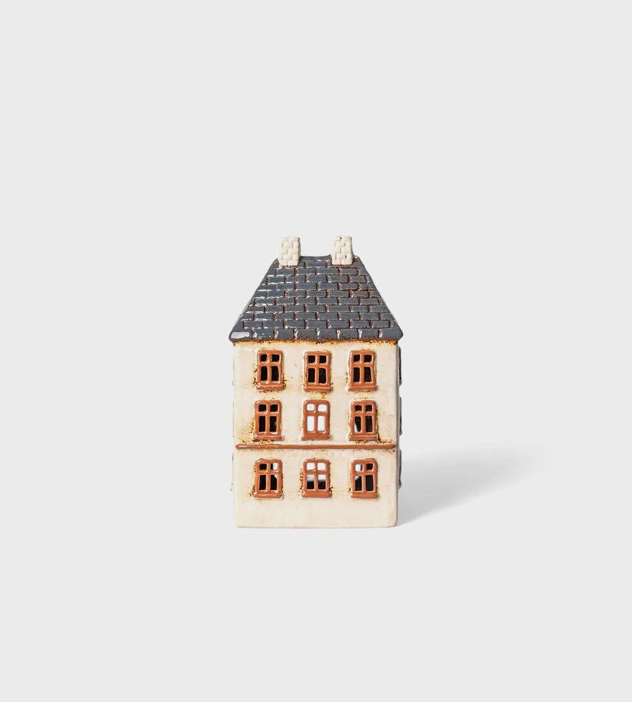 Small model of a house on a light gray background