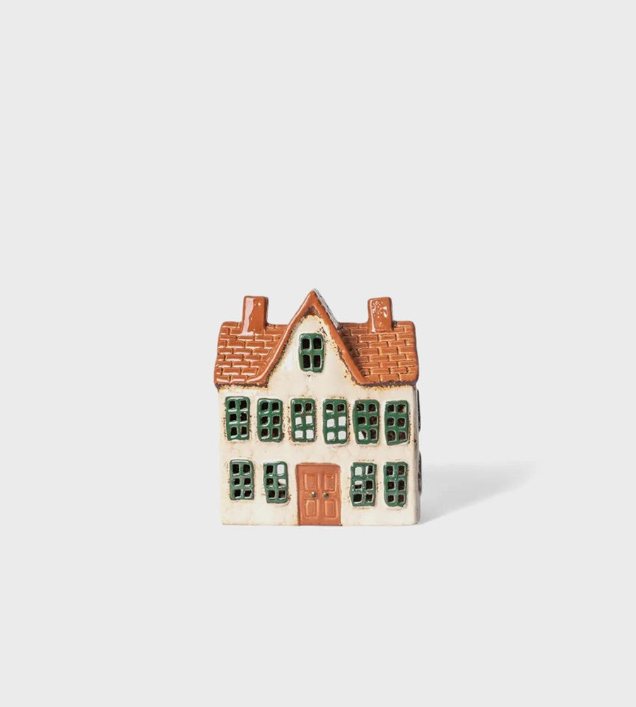 Small ceramic house with a brown roof on a white background