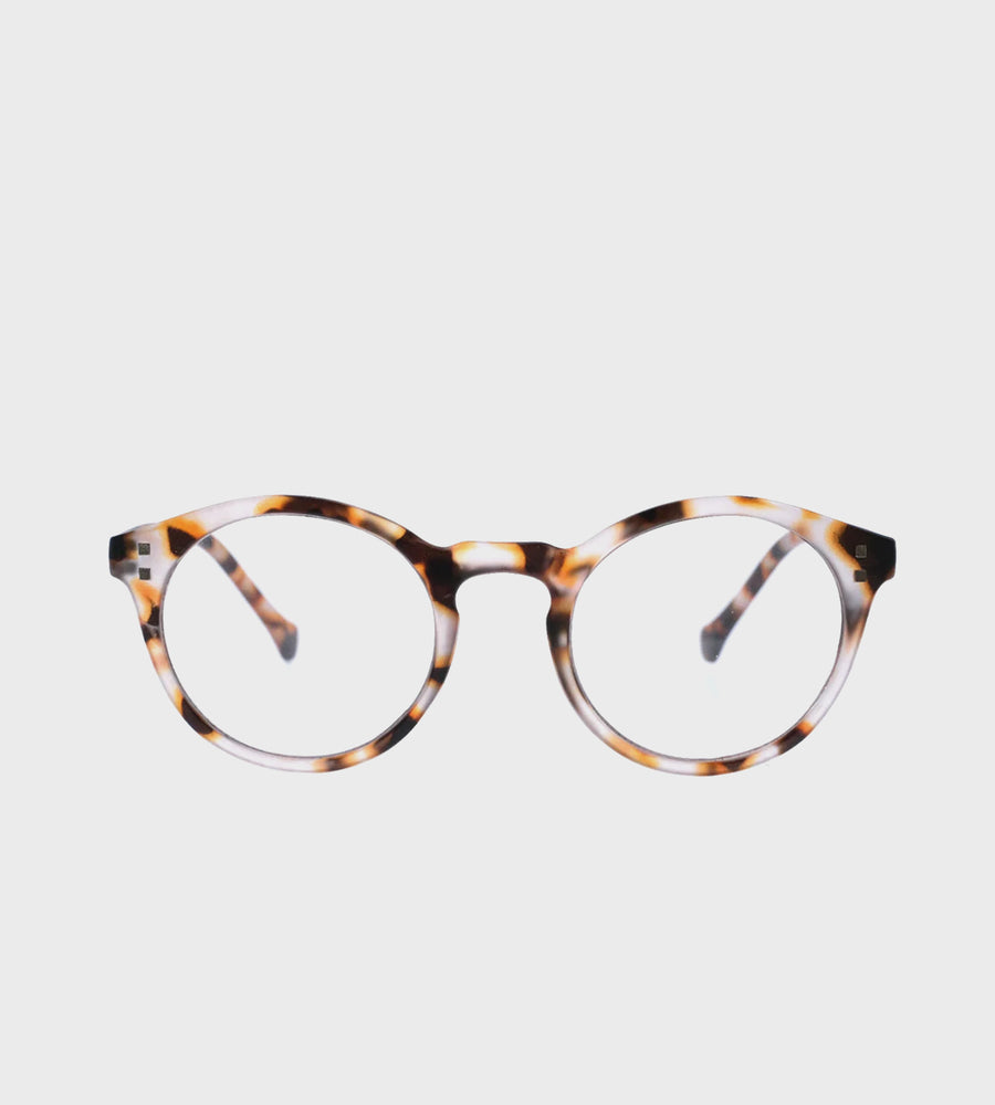 Tortoiseshell eyeglasses on a light gray background