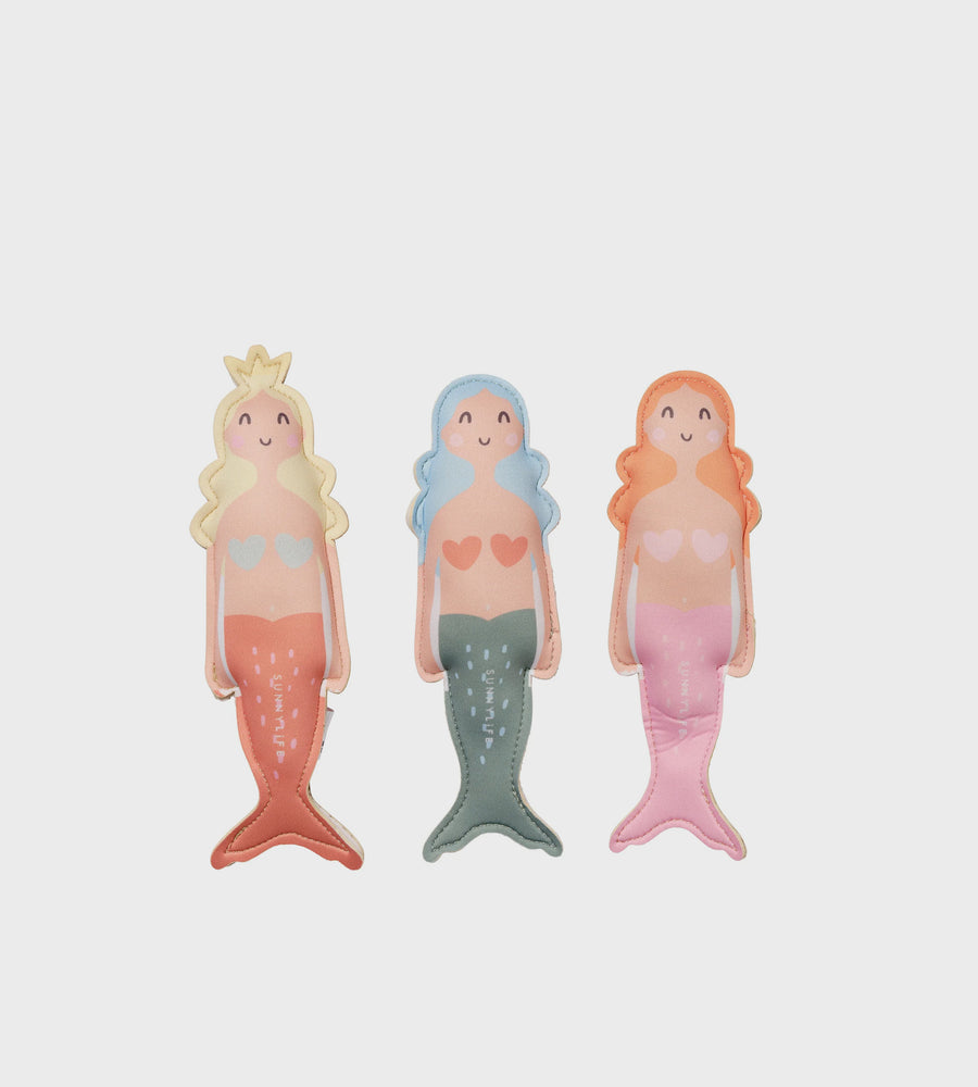 Three mermaid figurines with different hairstyles and colors on a light gray background